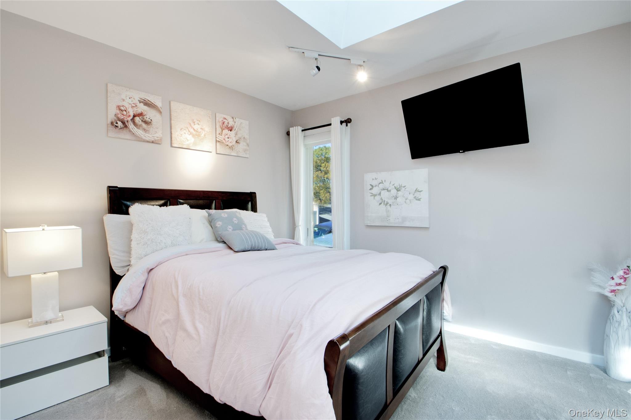 26 Summit Cir Drive Mahopac, NY 10541 - Photo 20 of 32 a bedroom with a bed and a flat screen tv