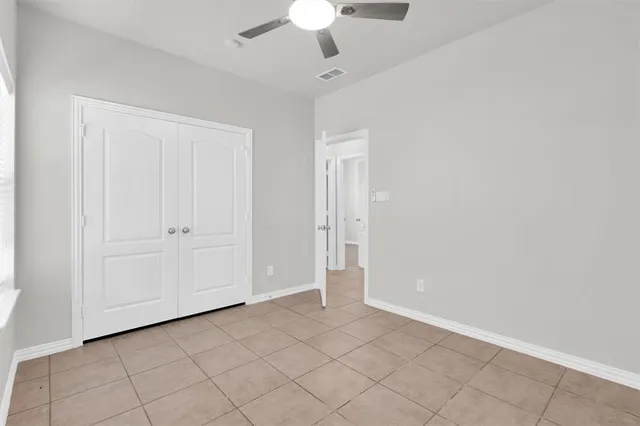 a view of a livingroom with a ceiling fan and window