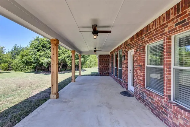 a view of a porch with furniture and floor to ceiling window