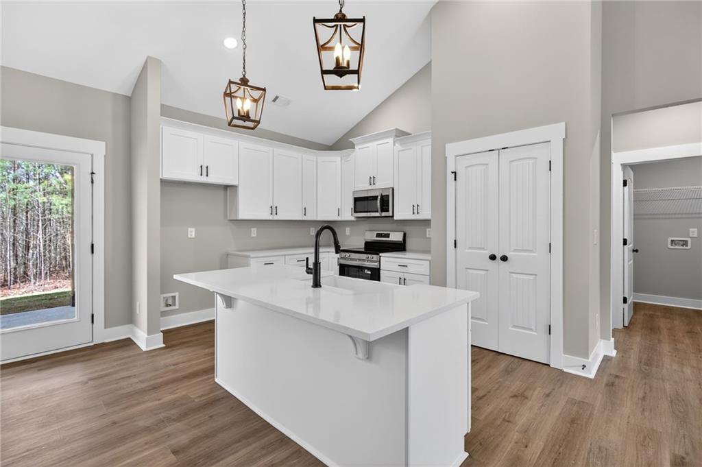 423 Relay Road Silver Creek, GA 30173 - Photo 20 of 48 a kitchen with stainless steel appliances a white stove top oven and a refrigerator