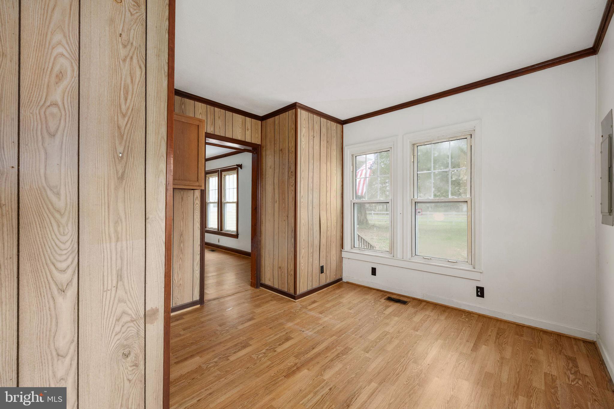 1881 Fairport Road Reedville, VA 22539 - Photo 28 of 57 an empty room with wooden floor and windows