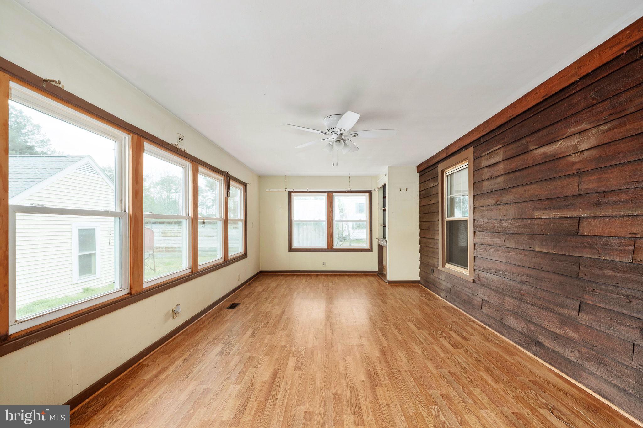 1881 Fairport Road Reedville, VA 22539 - Photo 44 of 57 a view of an empty room with wooden floor and a window