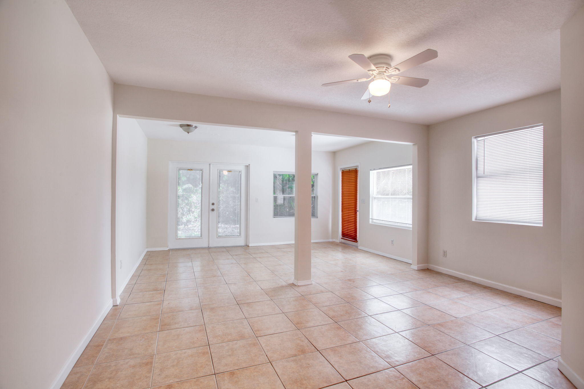 4302 Southwest Jaunt Road Port St. Lucie, FL 34953 - Photo 16 of 32 a view of a livingroom with a chandelier fan and windows