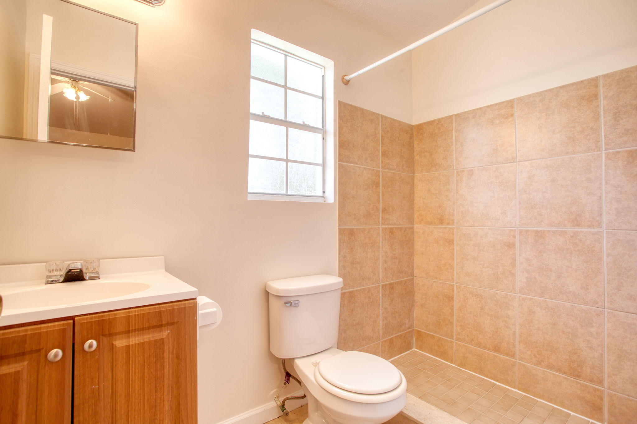 4302 Southwest Jaunt Road Port St. Lucie, FL 34953 - Photo 20 of 32 a bathroom with a sink a toilet and shower