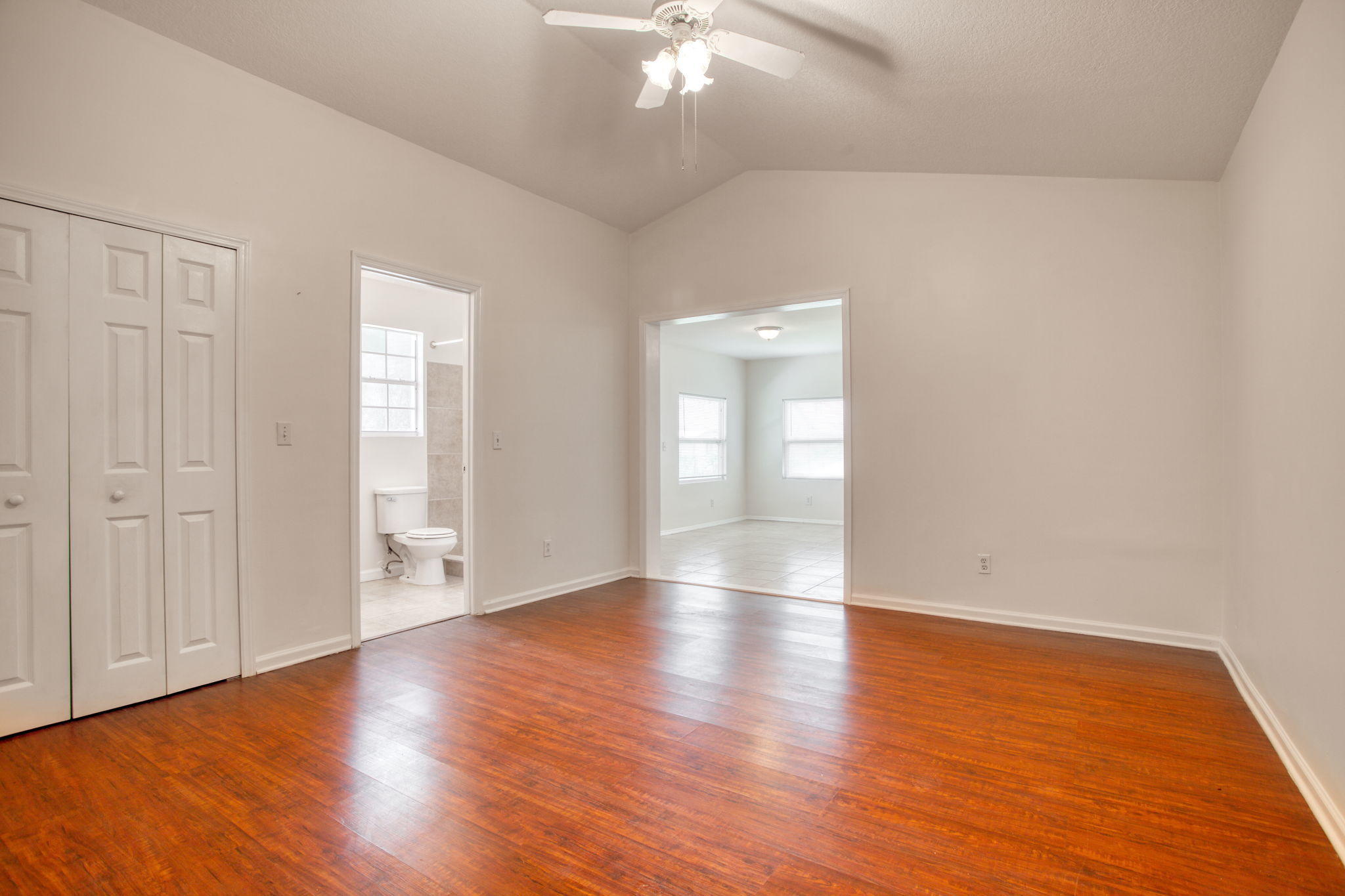 4302 Southwest Jaunt Road Port St. Lucie, FL 34953 - Photo 26 of 32 a view of an empty room with wooden floor and a window