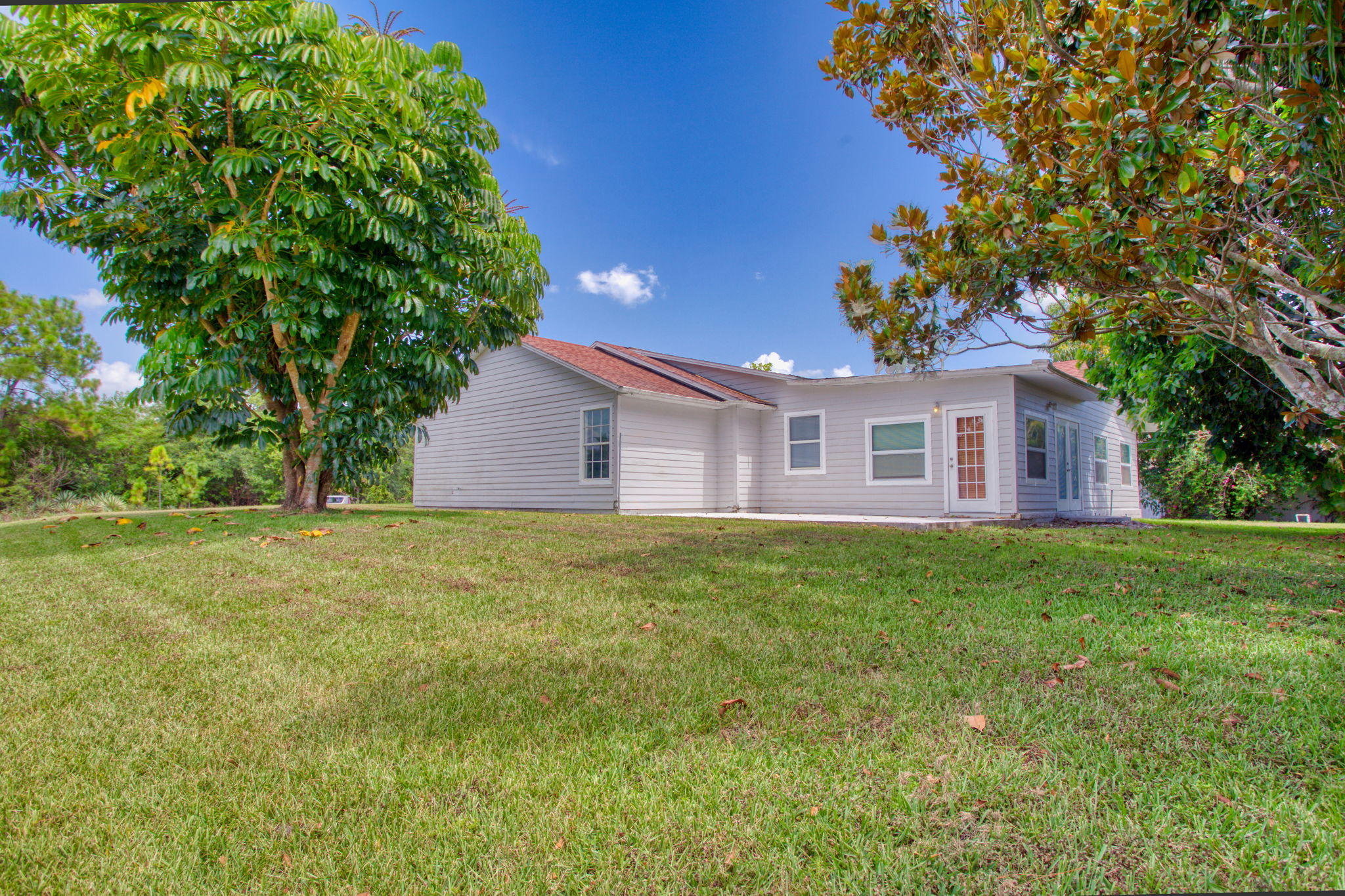 4302 Southwest Jaunt Road Port St. Lucie, FL 34953 - Photo 5 of 32 a view of a house with backyard and garden