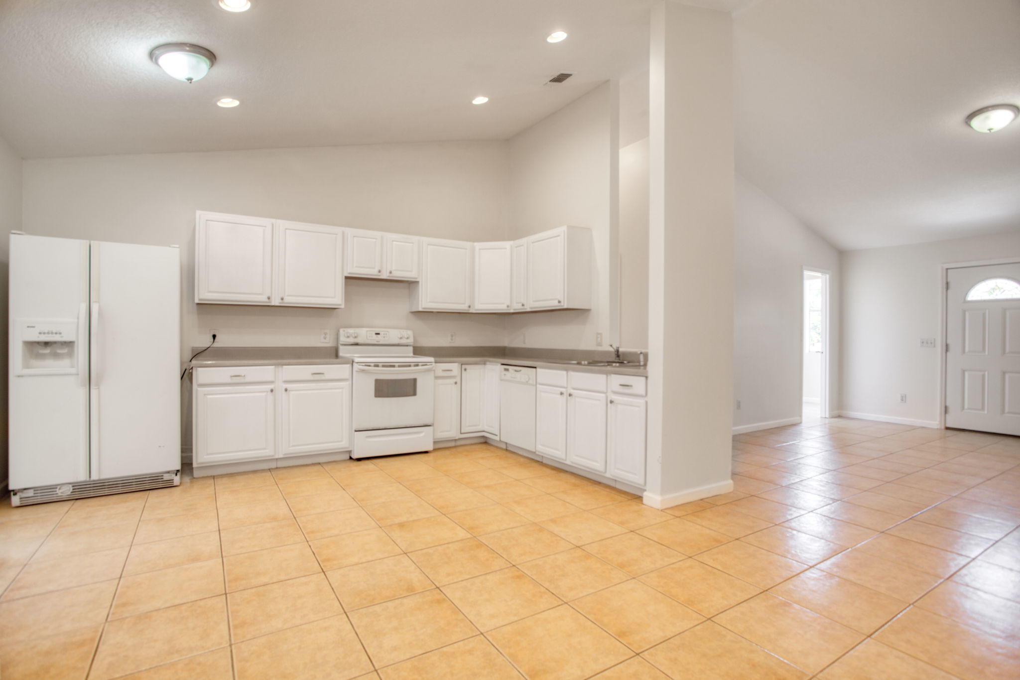 4302 Southwest Jaunt Road Port St. Lucie, FL 34953 - Photo 9 of 32 a kitchen with stainless steel appliances a cabinets and a counter top space