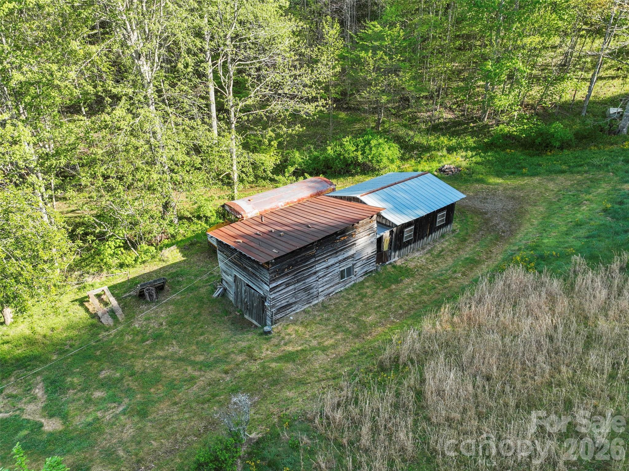 3454 Puncheon Fork Road Mars Hill, NC 28754 - Photo 13 of 18 a view of a backyard with chairs