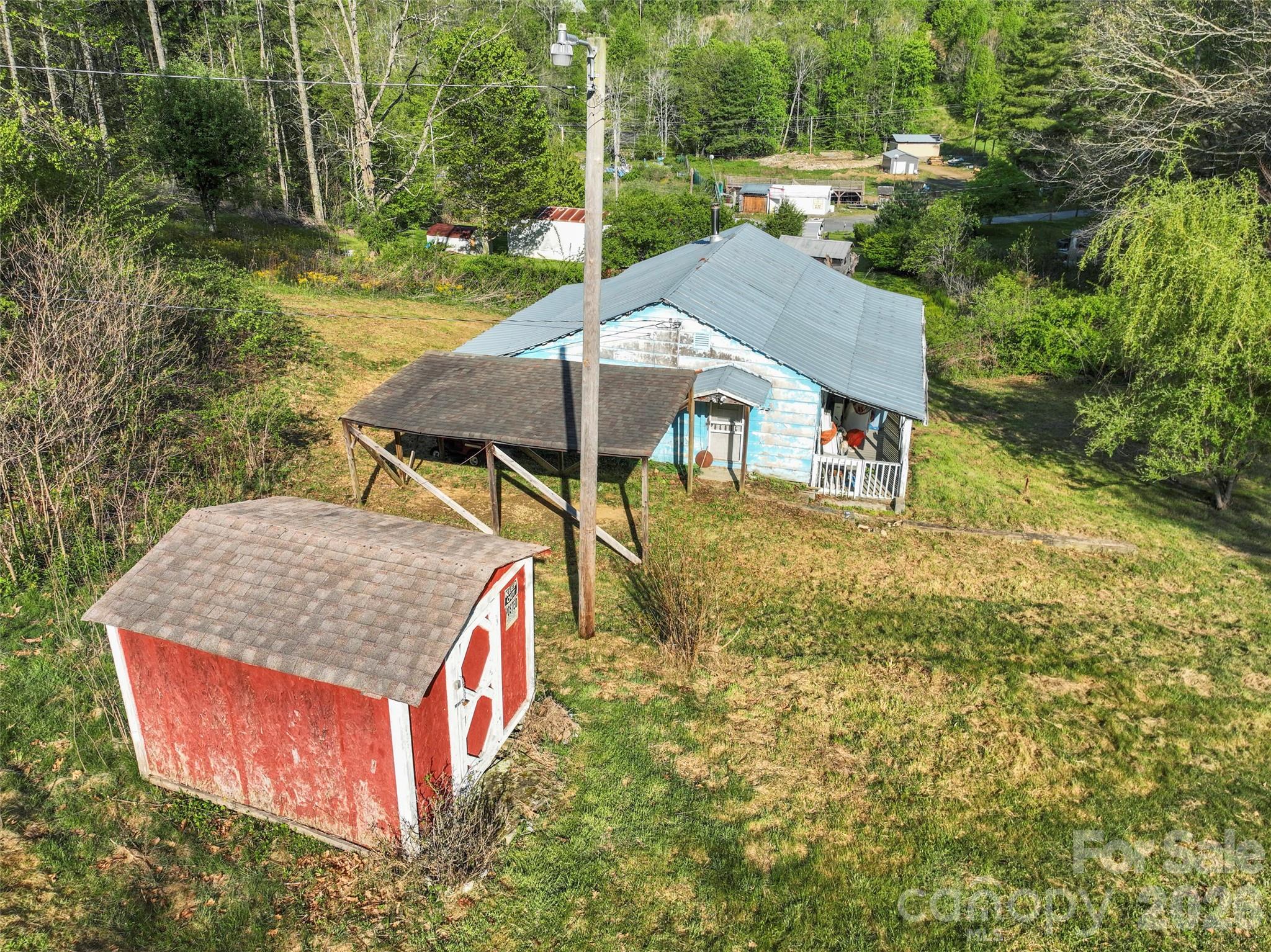 3454 Puncheon Fork Road Mars Hill, NC 28754 - Photo 10 of 18 an aerial view of a house with swimming pool and large trees