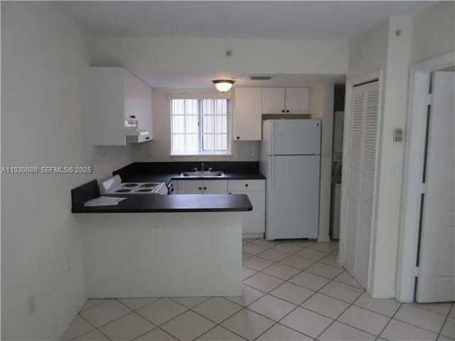 a kitchen with a sink appliances and cabinets