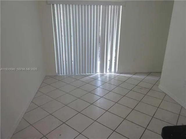 a view of a white wall & window