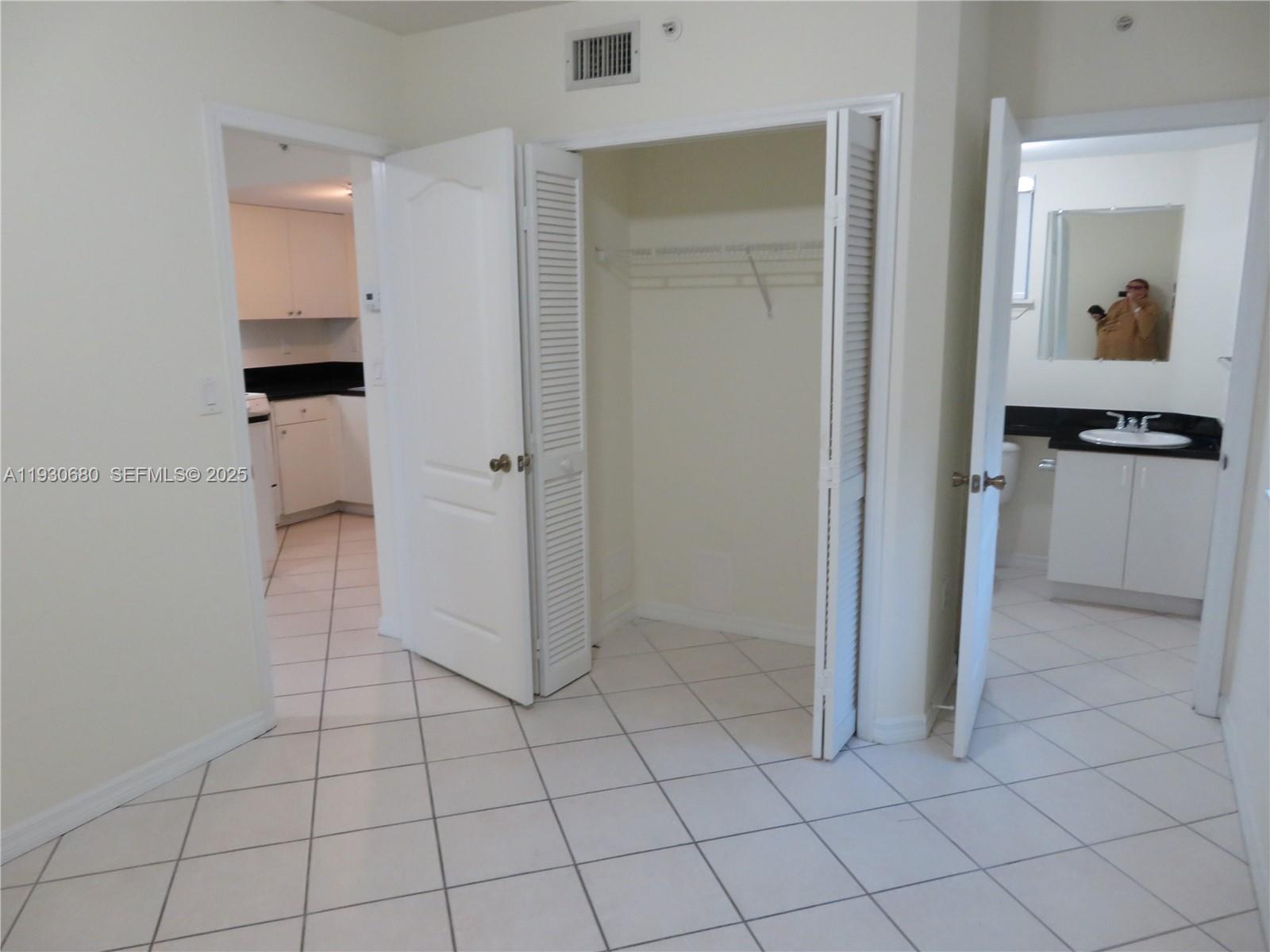 3090 Bird Avenue, Unit 203 Coconut Grove, FL 33133 - Photo 7 of 18 an empty room with cabinet and mirror