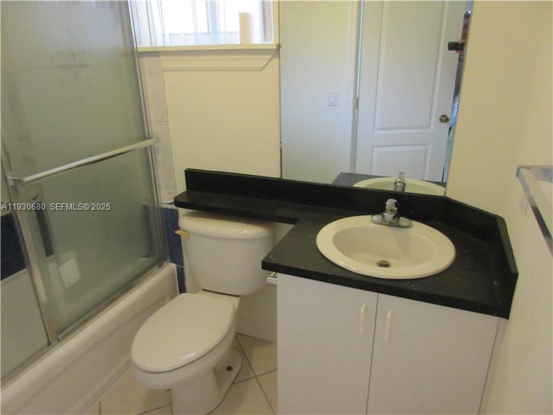 3090 Bird Avenue, Unit 203 Coconut Grove, FL 33133 - Photo 8 of 18 a bathroom with a sink and a mirror