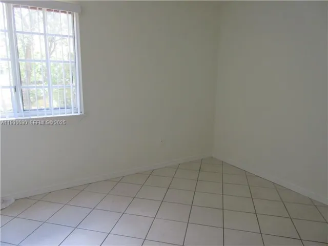 an empty room with a empty space and window