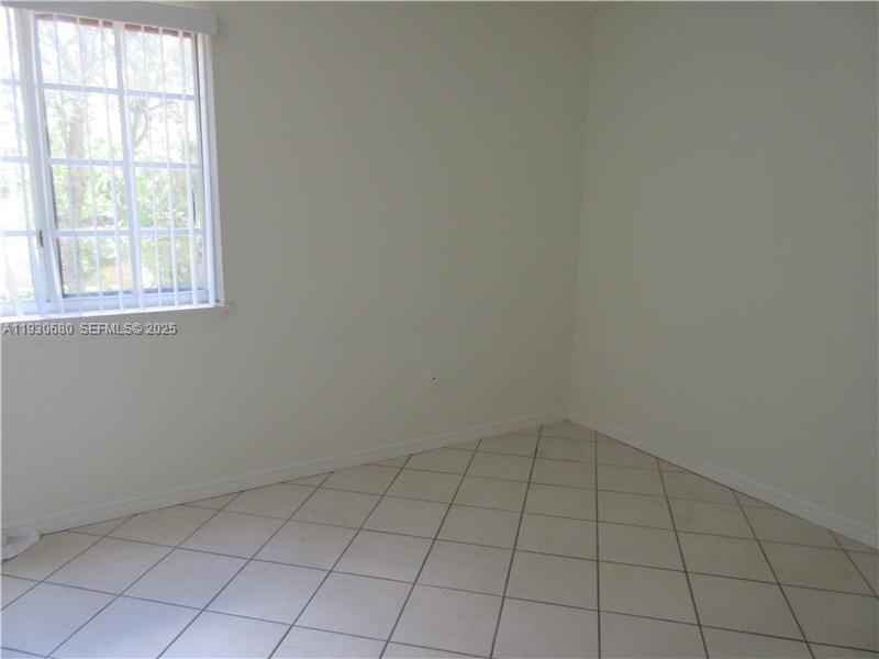 3090 Bird Avenue, Unit 203 Coconut Grove, FL 33133 - Photo 10 of 18 an empty room with a empty space and window