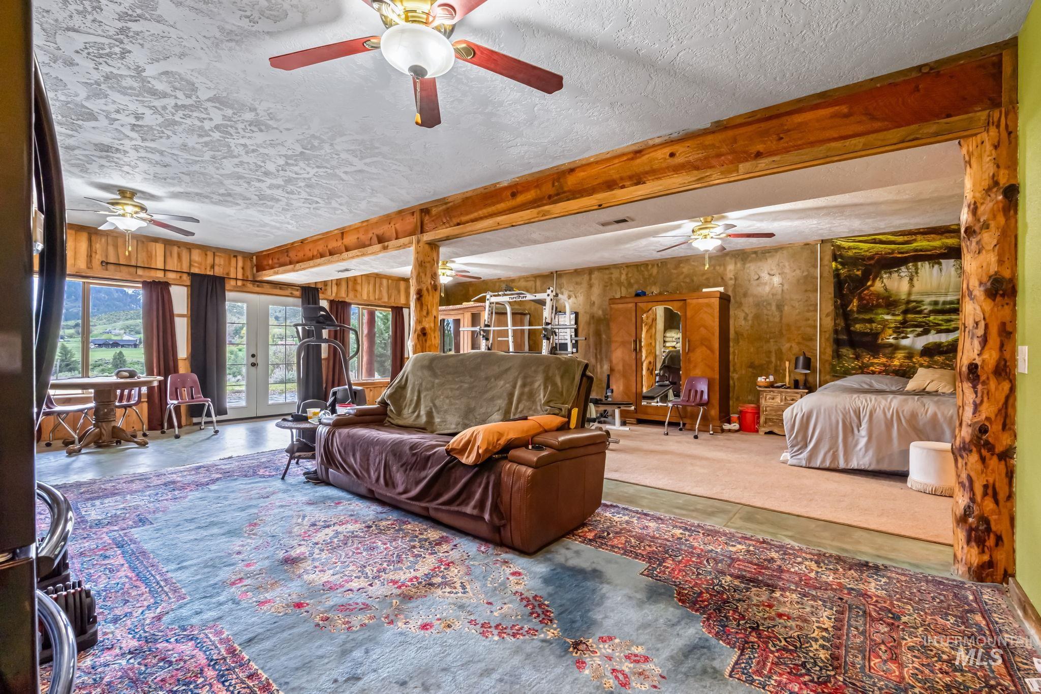 15 Rim Canyon Lane Boise, ID 83716 - Photo 15 of 31 Living room with french doors, a textured ceiling, and wooden walls