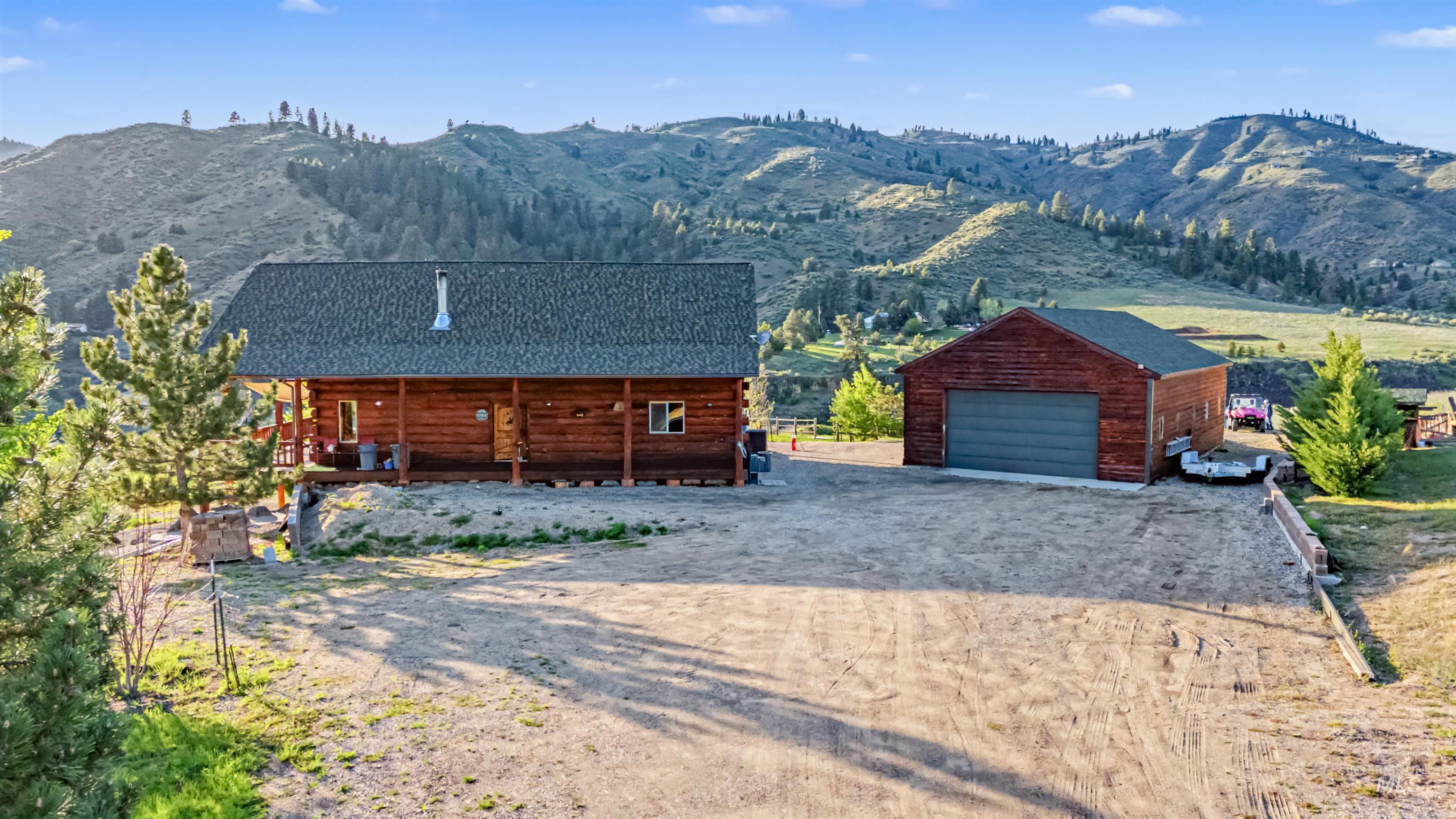 15 Rim Canyon Lane Boise, ID 83716 - Photo 24 of 31 Cabin featuring an outdoor structure, a mountain view, driveway, and a detached garage