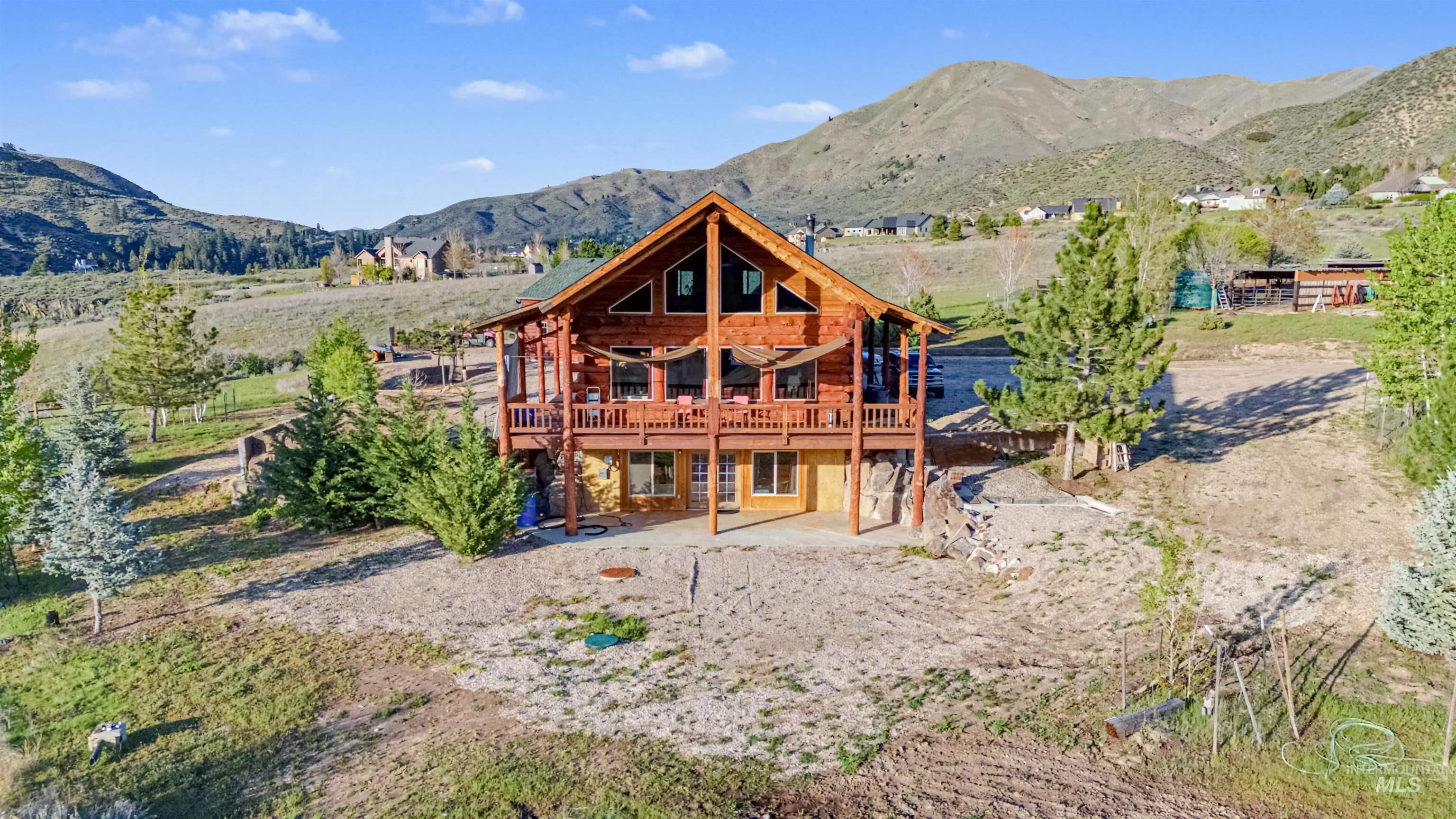 15 Rim Canyon Lane Boise, ID 83716 - Photo 26 of 31 Back of house featuring a patio, log siding, and a deck with mountain view
