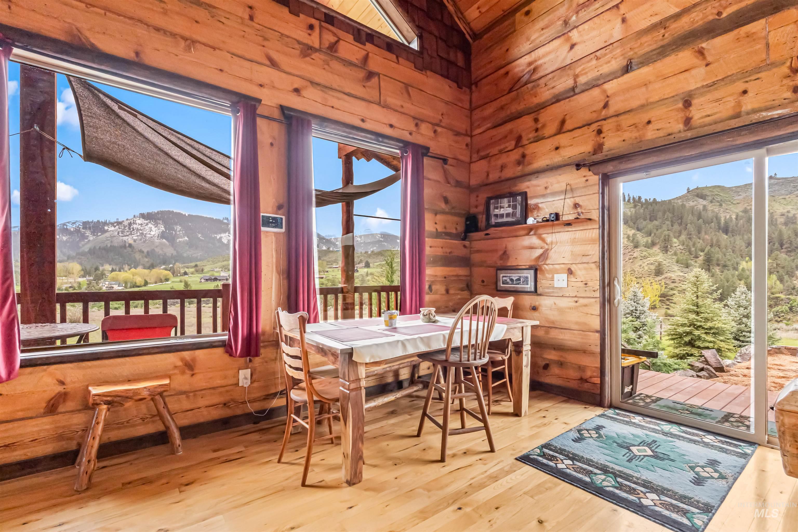 15 Rim Canyon Lane Boise, ID 83716 - Photo 7 of 31 Dining space with a mountain view, wooden walls, and hardwood / wood-style floors