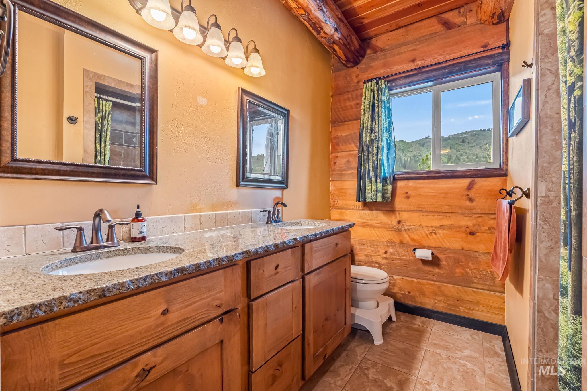 15 Rim Canyon Lane Boise, ID 83716 - Photo 9 of 31 Full bathroom featuring curtained shower, double vanity, wooden ceiling, and light tile patterned flooring