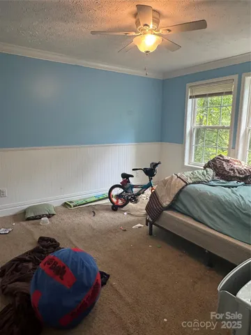 a bed room with a bed and a chandelier