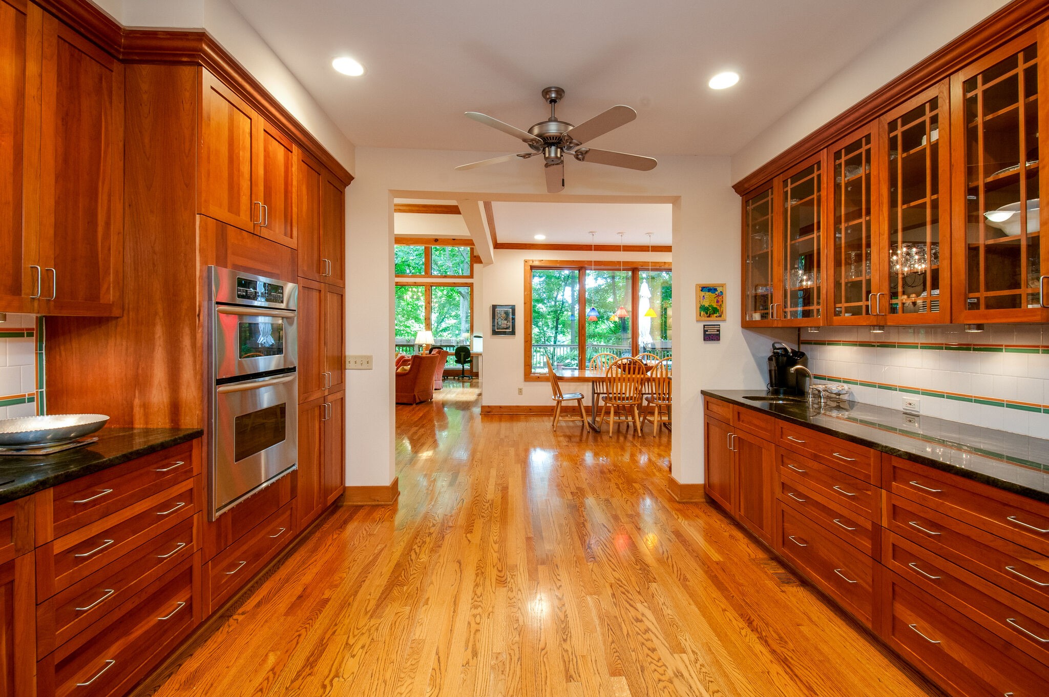 438 Grayson Drive Nashville, TN 37205 - Photo 11 of 36 a kitchen with stainless steel appliances granite countertop a refrigerator a stove top oven a chimney wooden floor and cabinets