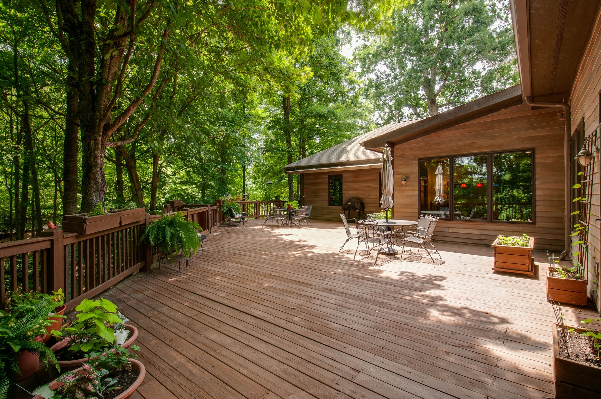 438 Grayson Drive Nashville, TN 37205 - Photo 27 of 36 a view of a patio with table and chairs potted plants with wooden floor and fence