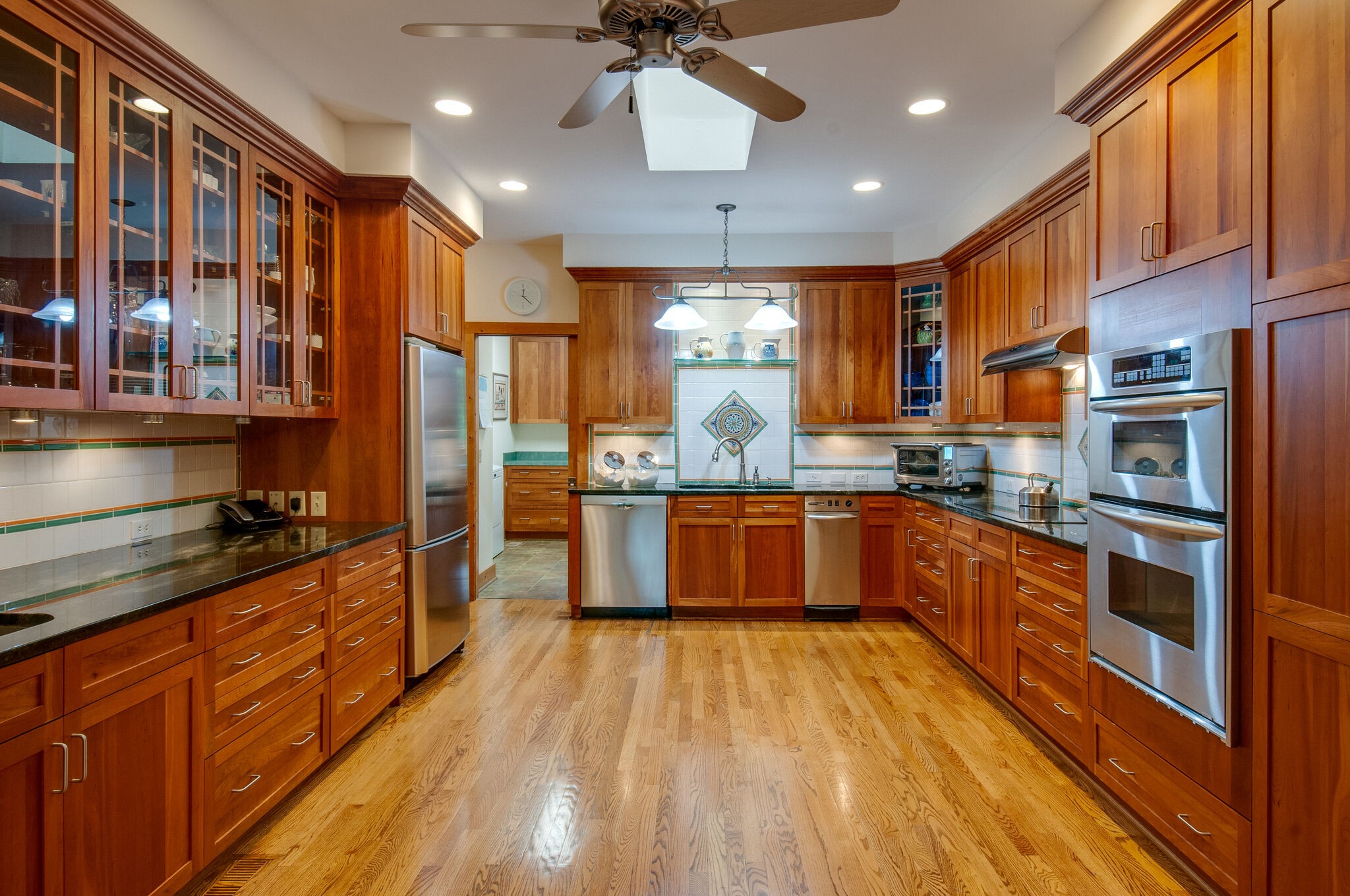 438 Grayson Drive Nashville, TN 37205 - Photo 8 of 36 a large kitchen with stainless steel appliances granite countertop a large stove top oven a sink dishwasher and wooden cabinets with wooden floor