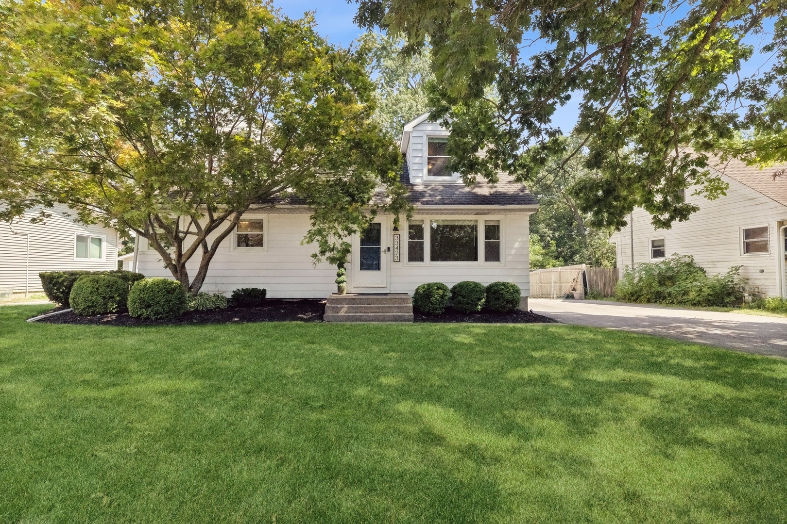 a front view of a house with a garden