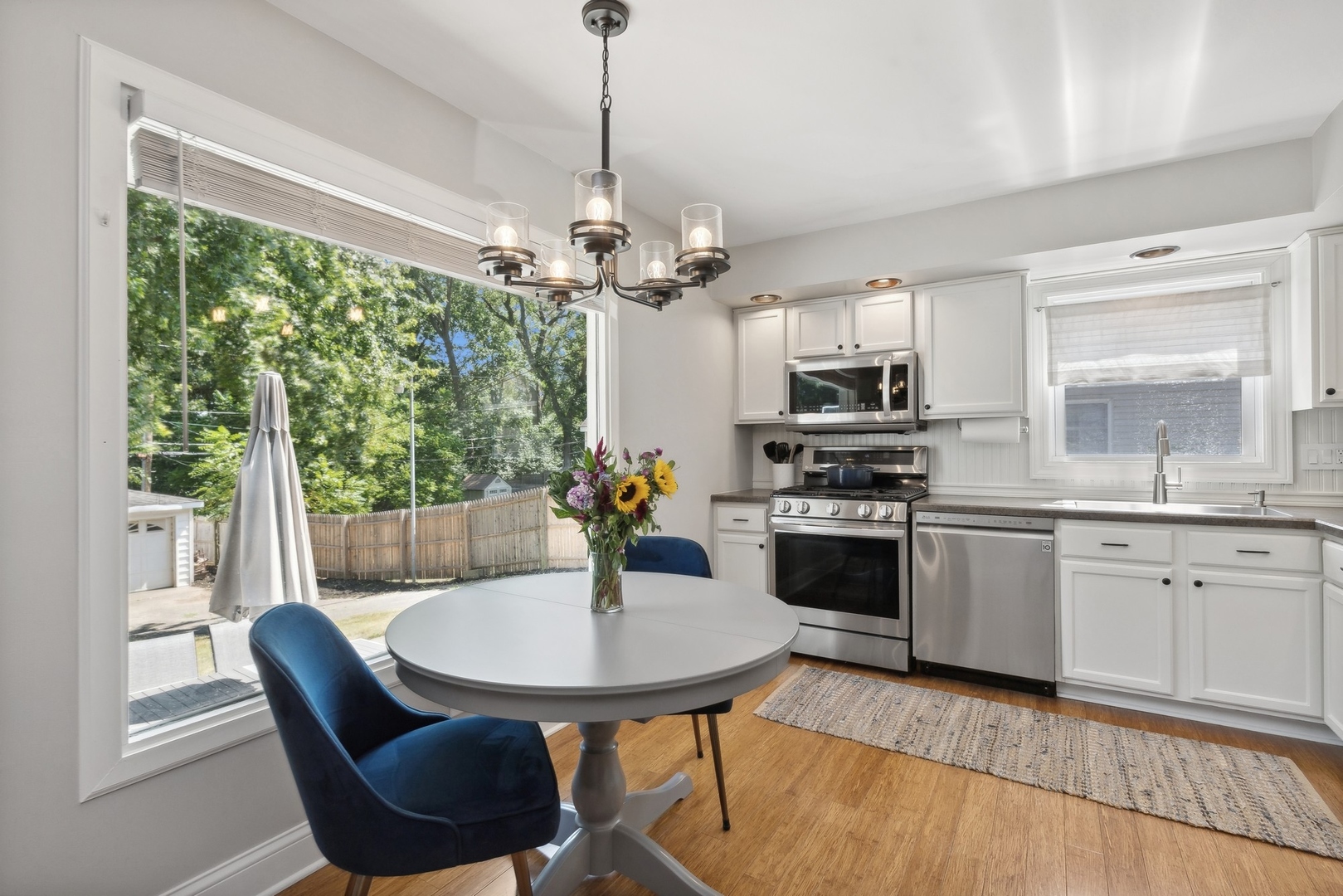33423 North Mill Road Grayslake, IL 60030 - Photo 2 of 22 a kitchen with a table chairs and white cabinets