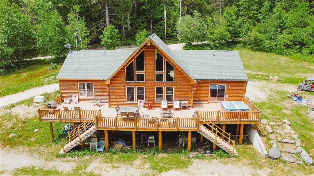 123 Davis Mine Road Rowe, MA 01367 - Photo 1 of 41 an aerial view of a house with swimming pool and sitting area