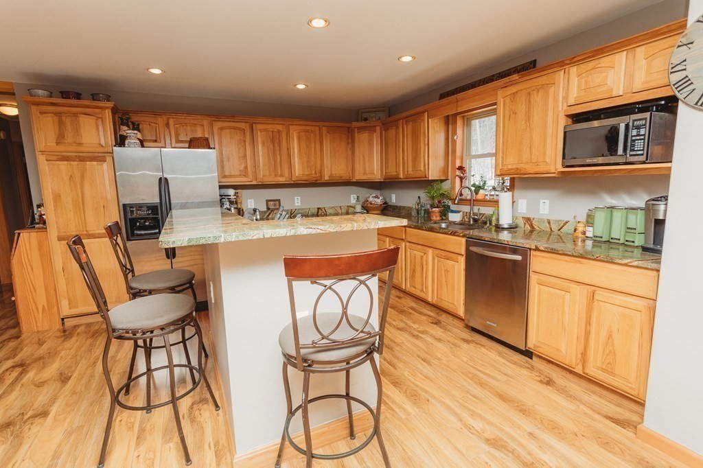 123 Davis Mine Road Rowe, MA 01367 - Photo 11 of 41 a kitchen with a table chairs refrigerator and cabinets