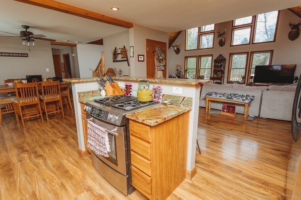 123 Davis Mine Road Rowe, MA 01367 - Photo 14 of 41 a kitchen with stainless steel appliances granite countertop a stove and a wooden floors