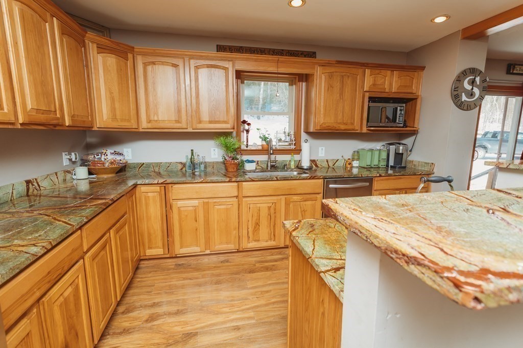 123 Davis Mine Road Rowe, MA 01367 - Photo 15 of 41 a kitchen with stainless steel appliances wooden cabinets a sink and a stove