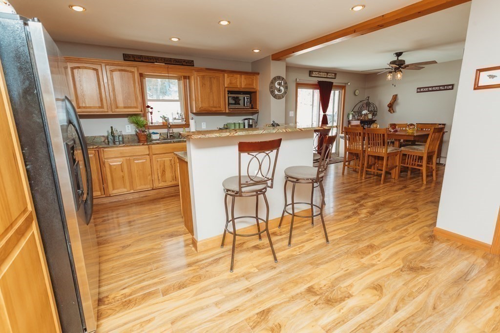 123 Davis Mine Road Rowe, MA 01367 - Photo 17 of 41 a kitchen with stainless steel appliances kitchen island granite countertop a table and chairs in it