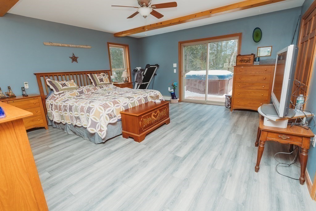 123 Davis Mine Road Rowe, MA 01367 - Photo 22 of 41 a bedroom with a bed and wooden floor