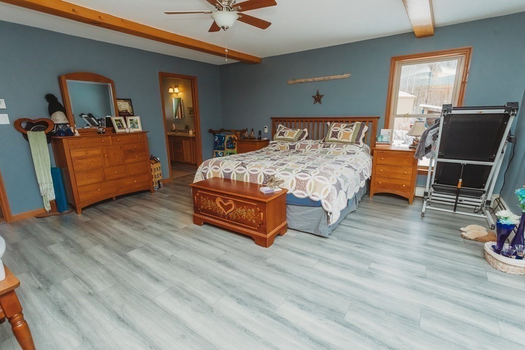 123 Davis Mine Road Rowe, MA 01367 - Photo 23 of 41 a bedroom with a bed and wooden floor