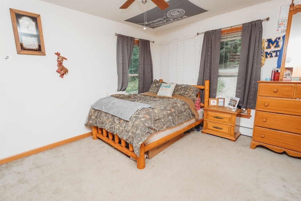 123 Davis Mine Road Rowe, MA 01367 - Photo 29 of 41 a bedroom with a bed and wooden floor