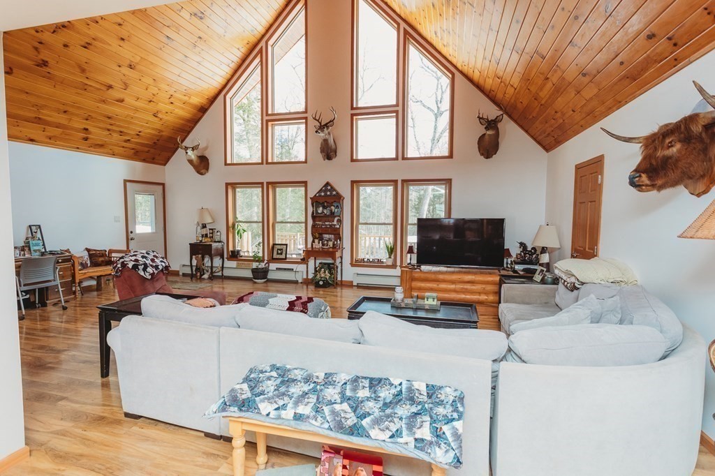 123 Davis Mine Road Rowe, MA 01367 - Photo 8 of 41 a living room with furniture a fireplace and a large window