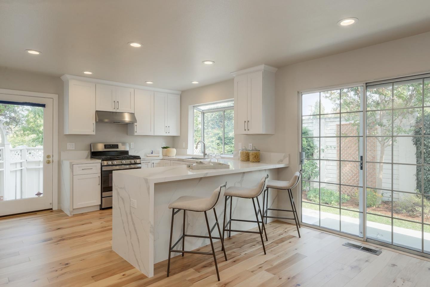 305 Windmill Park Lane Mountain View, CA 94043 - Photo 11 of 28 a kitchen with a stove a sink a refrigerator and a dining table