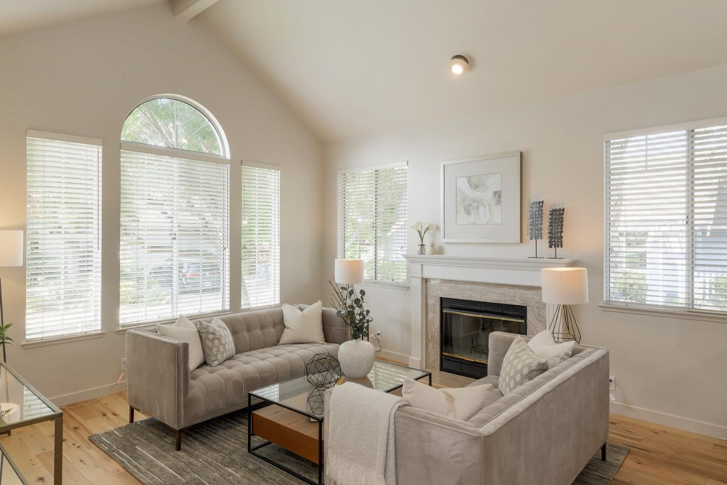 305 Windmill Park Lane Mountain View, CA 94043 - Photo 5 of 28 a living room with furniture a large window and a fireplace