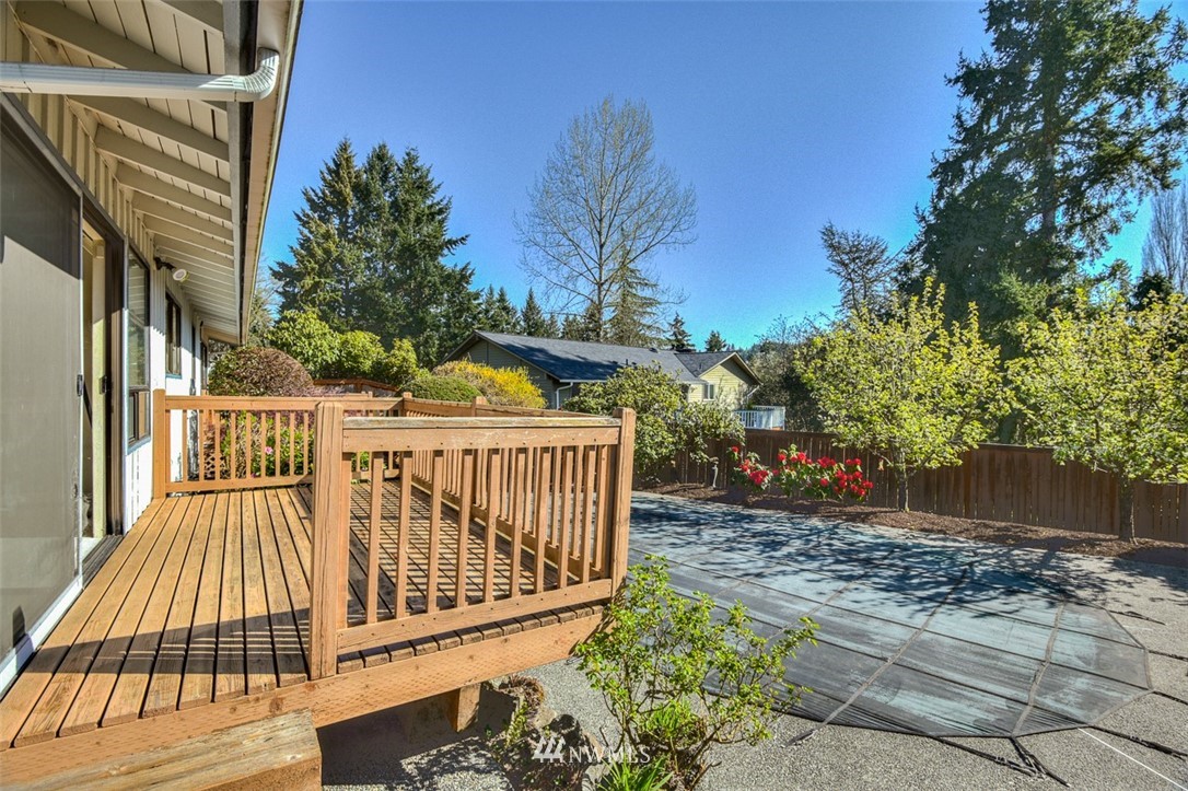 1822 234th Place Southwest Bothell, WA 98021 - Photo 22 of 23 a view of a wooden deck with a yard