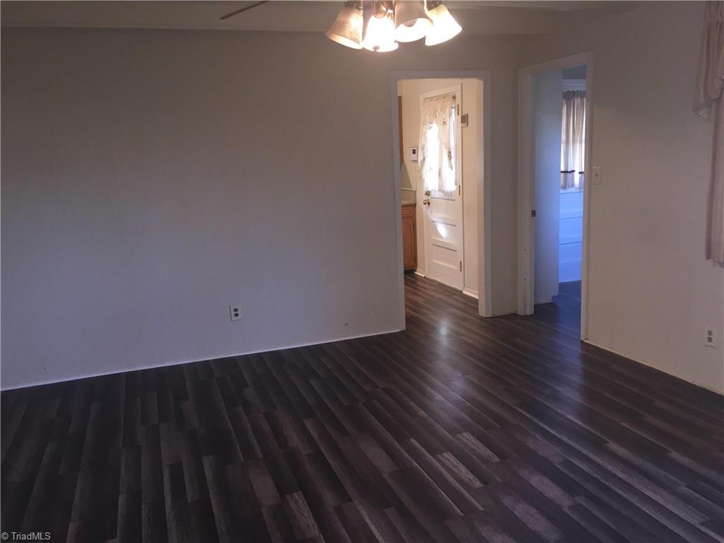 2208 Timberlake Avenue High Point, NC 27265 - Photo 4 of 18 Den with new flooring. Entrance to Kitchen is to left and doorway of laundry is to right
