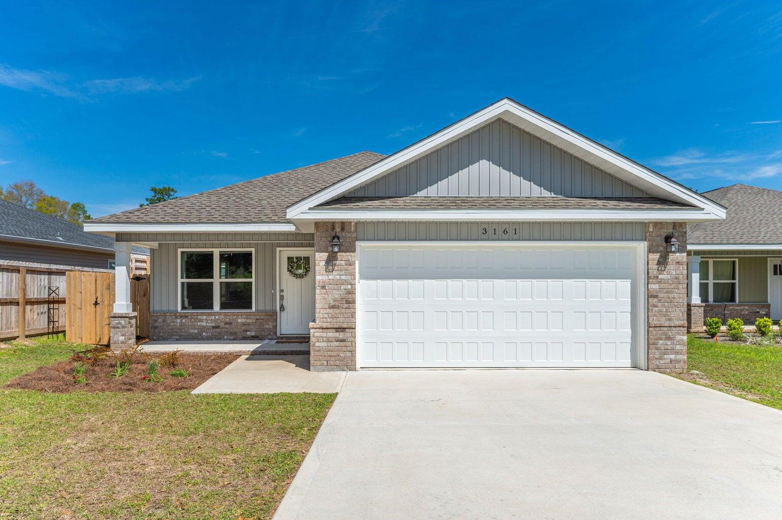 3161 Haskell Langley Road Crestview, FL 32539 - Photo 1 of 36 a front view of a house with a yard and garage