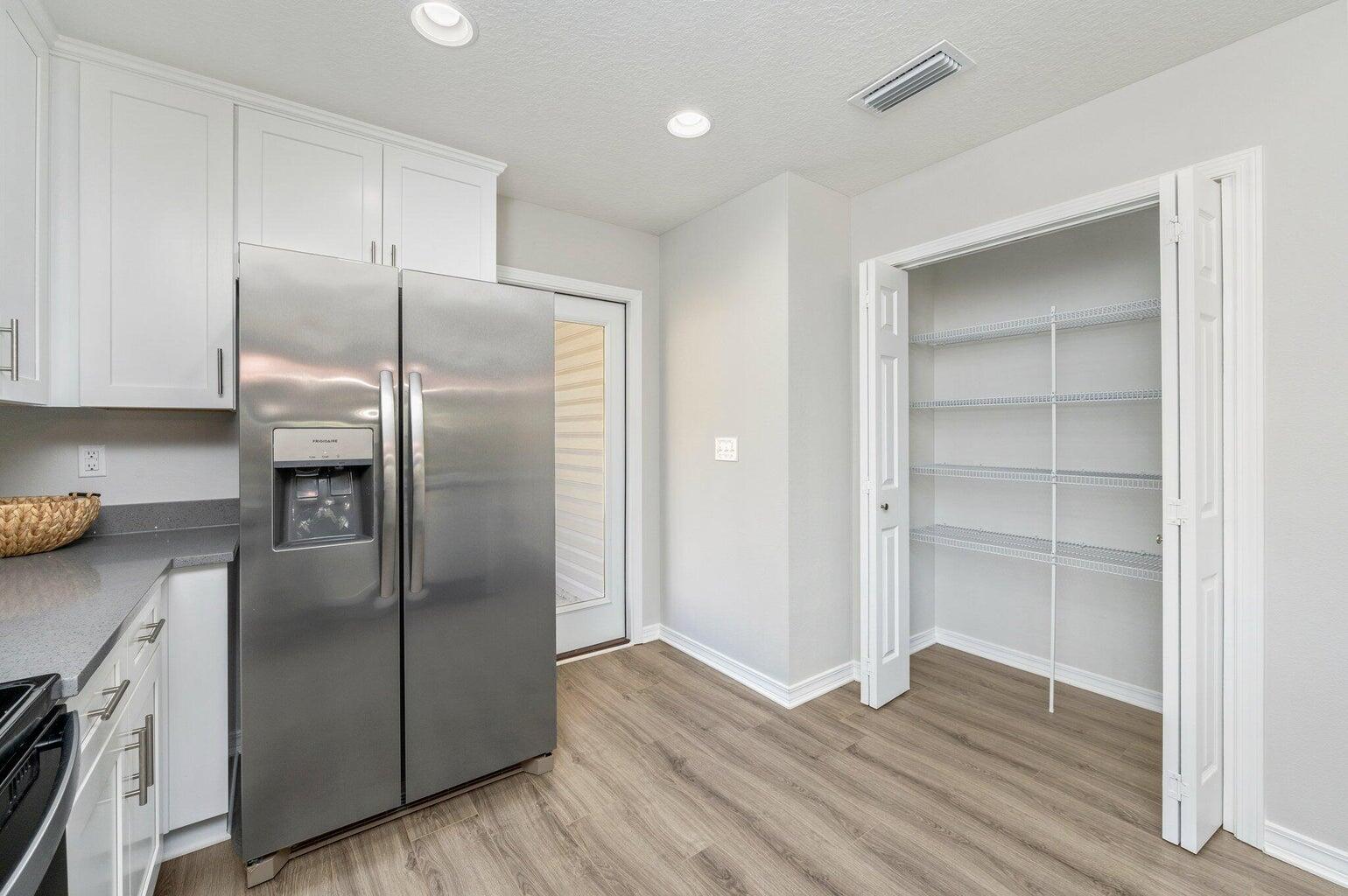 3161 Haskell Langley Road Crestview, FL 32539 - Photo 13 of 36 a kitchen with granite countertop stainless steel appliances refrigerator and cabinets