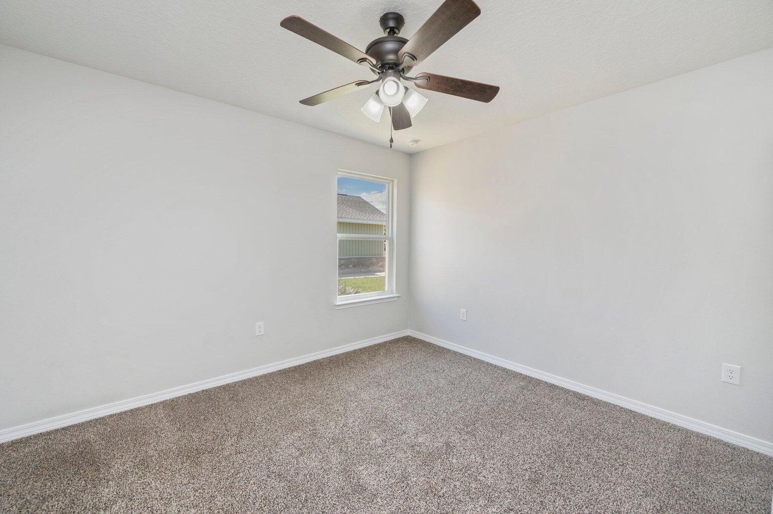 3161 Haskell Langley Road Crestview, FL 32539 - Photo 16 of 36 an empty room with a window and a fan