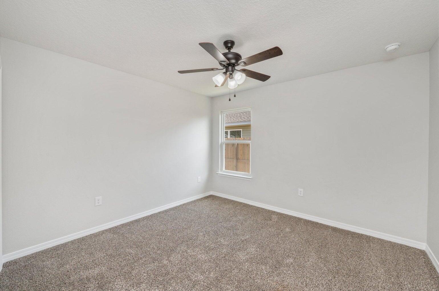 3161 Haskell Langley Road Crestview, FL 32539 - Photo 18 of 36 a view of a room with a ceiling fan and a window