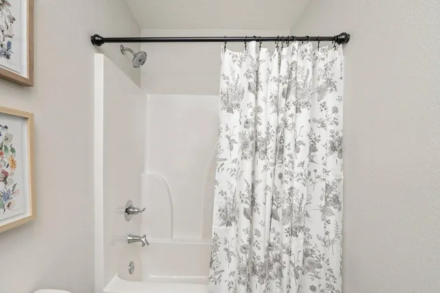 a bathroom with a shower curtain and a curtain