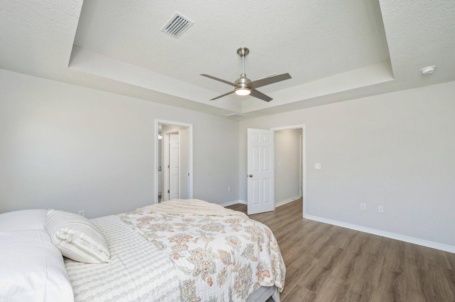3161 Haskell Langley Road Crestview, FL 32539 - Photo 23 of 36 a bedroom with a large bed and a chandelier