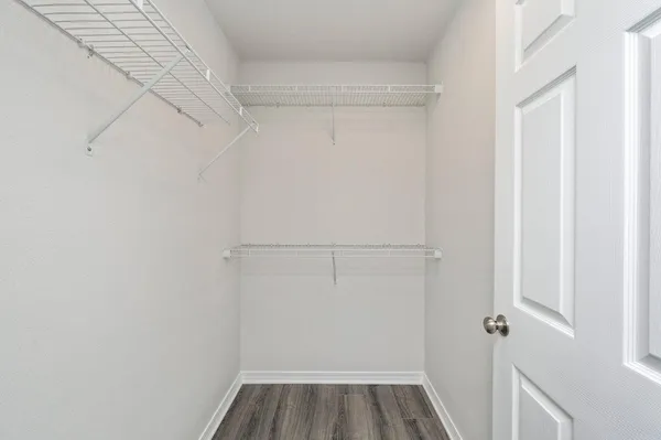 a view of walk in closet with empty racks